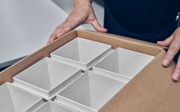 Cardboard cartons in a large open box