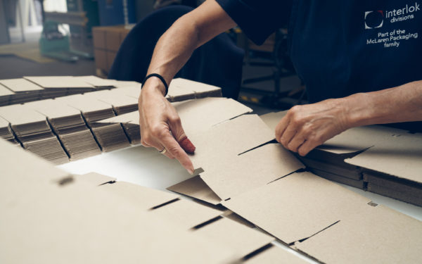Worker handling packaging divisions in the McLaren manufacturing base